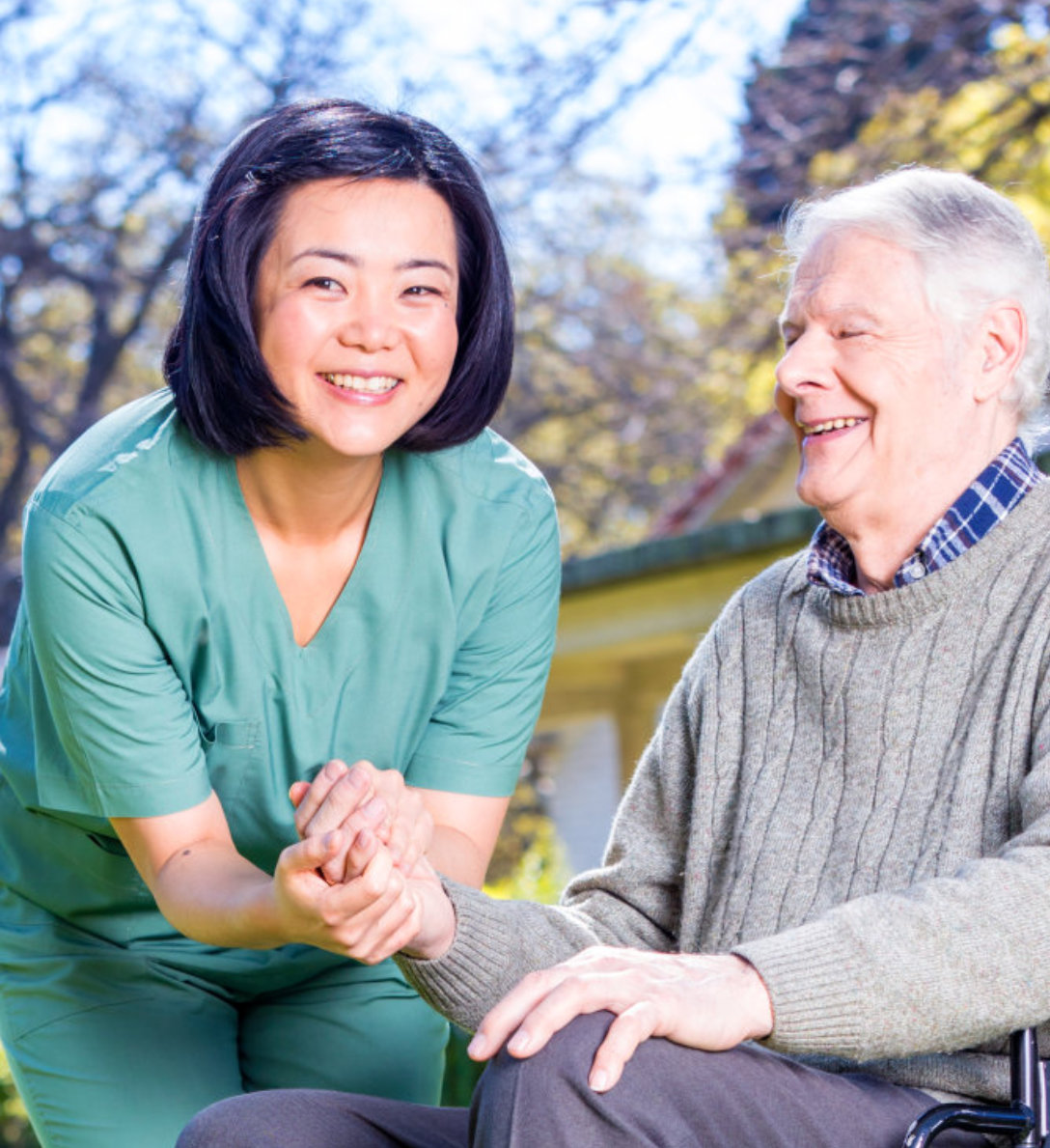 a female nurse smiling with an elderly man